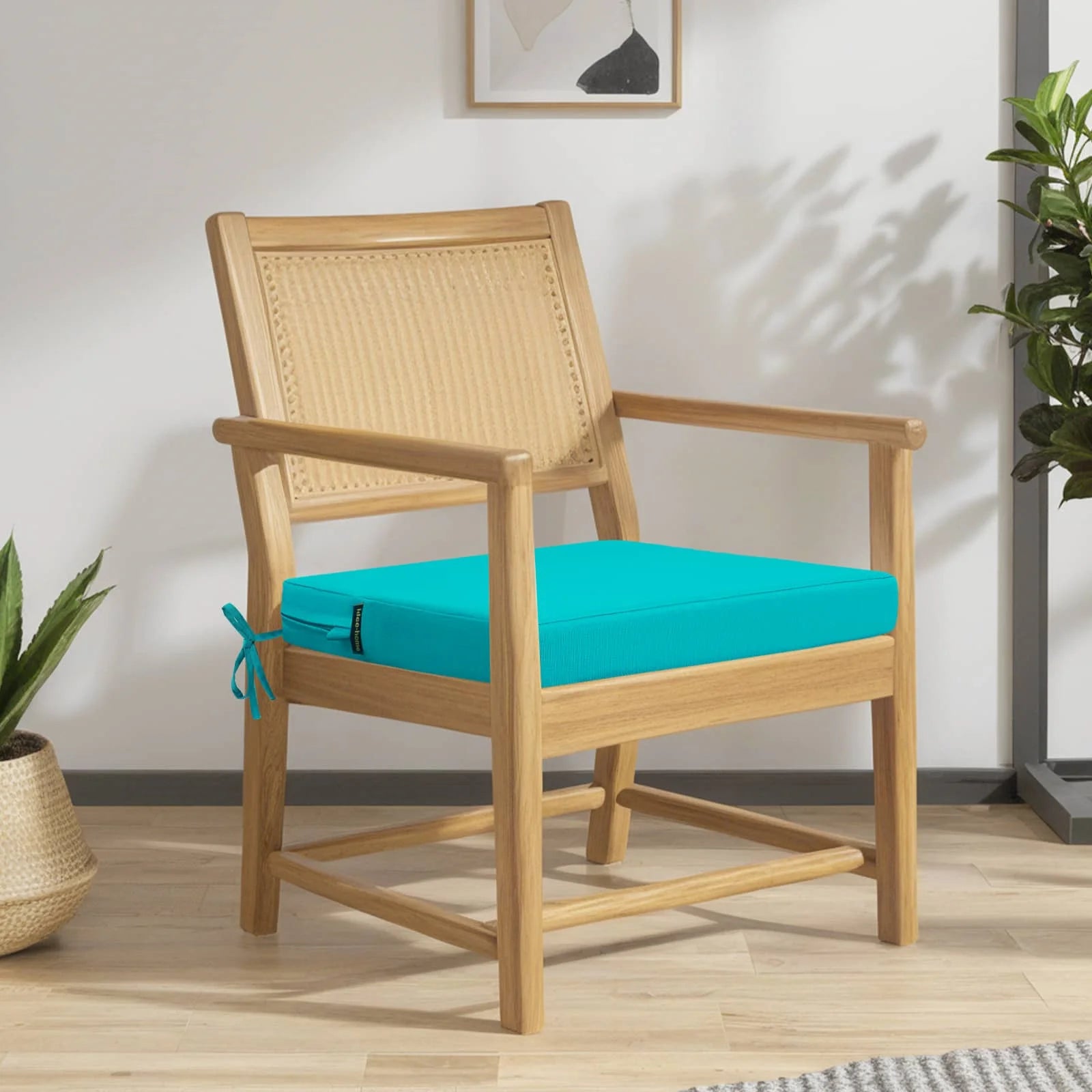 A wooden chair holds idee-home Peacock Blue Outdoor Chair Cushions