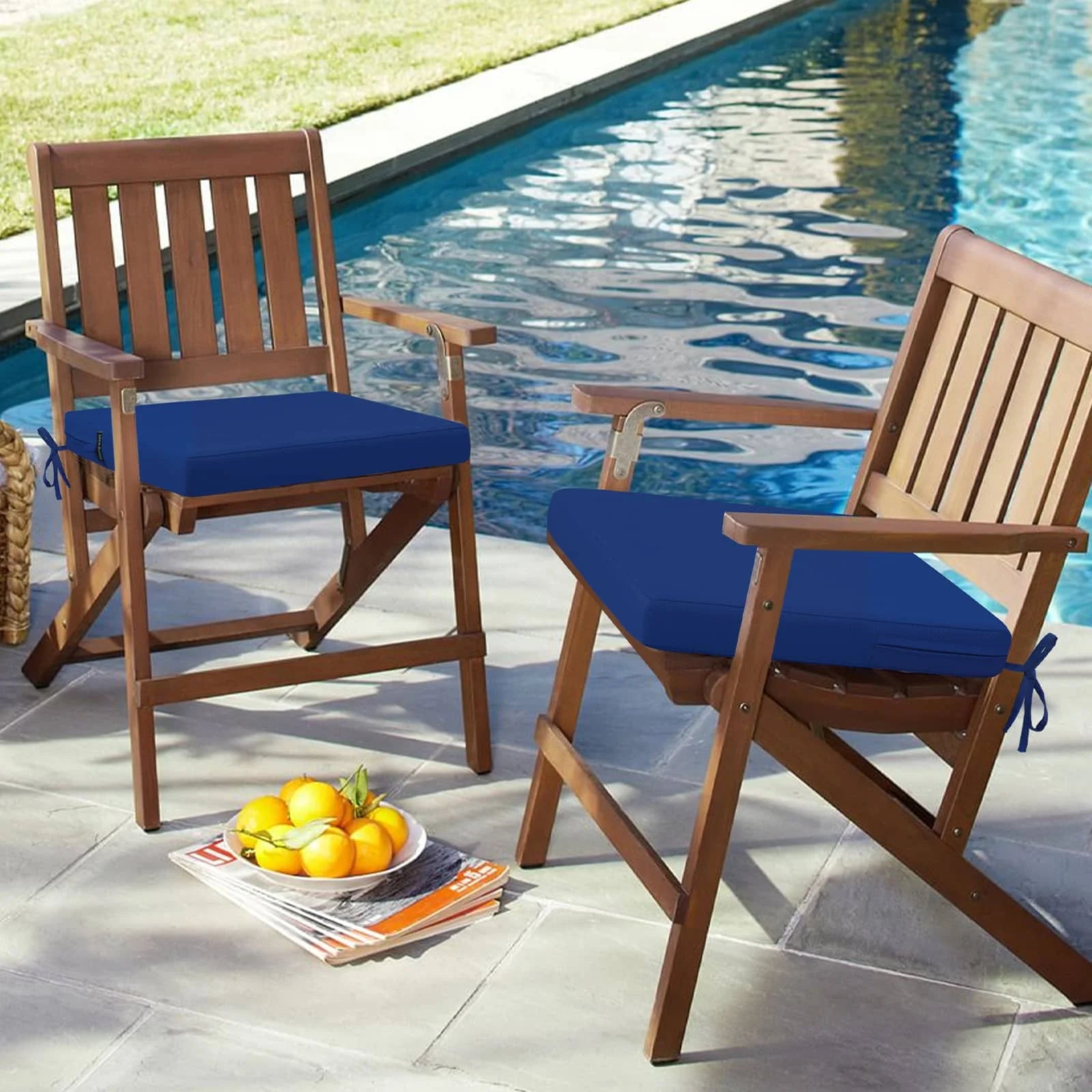 Two folding chairs placed by the outdoor pool hold idee-home Dark Cerulean Outdoor Chair Cushions