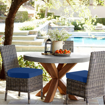 Two rattan chairs in the garden cushioned with idee-home Outdoor Chair Cushions - Dark Cerulean